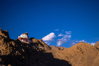 Panoramic view of rocky mountains against blue sky