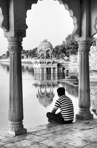 Tourists sitting in front of building