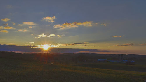 Scenic view of field against sky during sunset