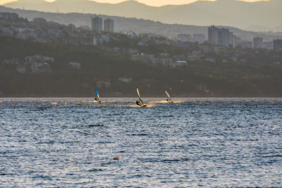 Scenic view of sea by buildings against sky