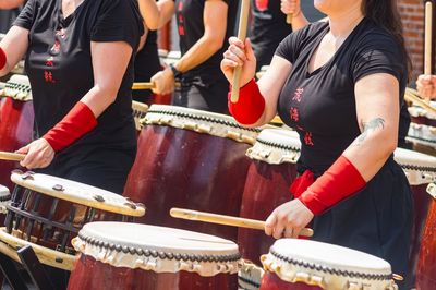 Low section of man playing drum