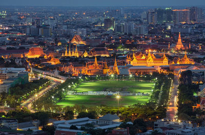 Aerial view of illuminated cityscape during sunset