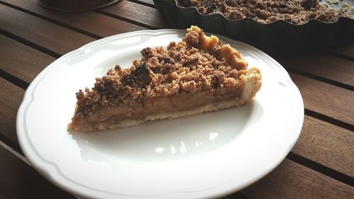 Close-up of apple pie served in plate on table