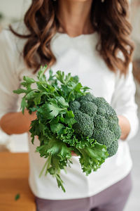 Midsection of woman holding food