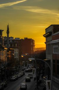 Traffic on road at sunset