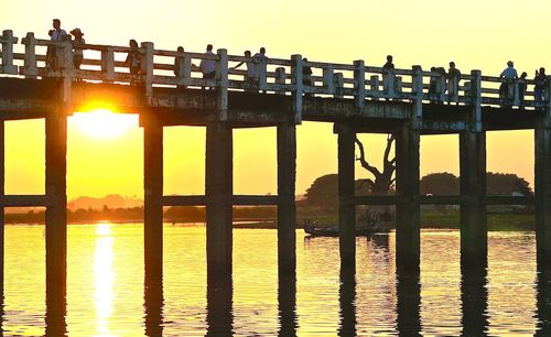 Pier on sea at sunset