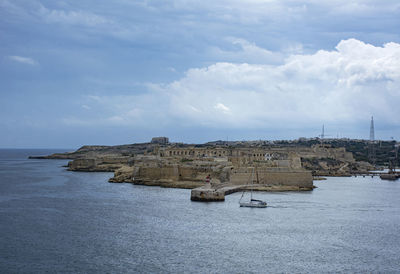 Scenic view of sea and buildings against sky