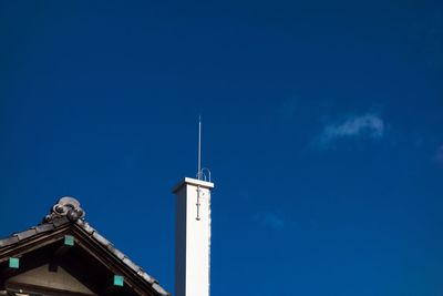 Low angle view of tower against blue sky