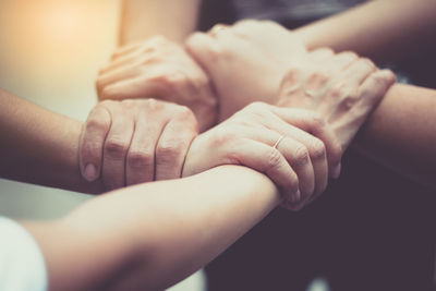 Cropped image of business people holding hands