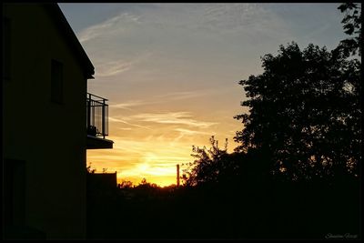 Silhouette of house at sunset