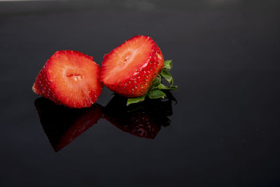 High angle view of strawberries on table against black background