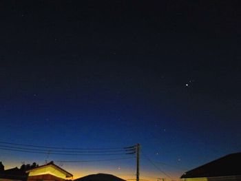 Low angle view of moon against clear sky at night