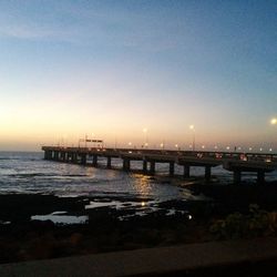 Pier on sea at night