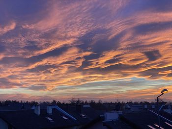 High angle view of silhouette buildings against sky during sunset