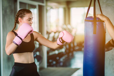 Young woman boxing in gym