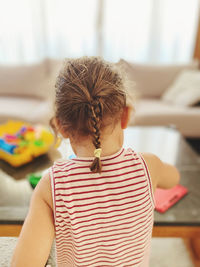 High angle view of girl playing on table