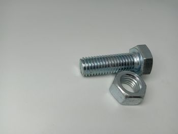 High angle view of metal on table against white background