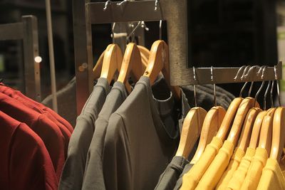 Close-up of clothes hanging on rack at store