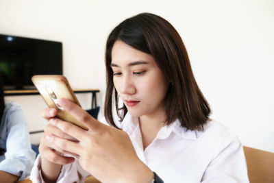 Portrait of young woman using mobile phone