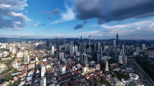 High angle view of modern buildings in city against sky