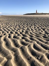 View of sandy beach against clear sky