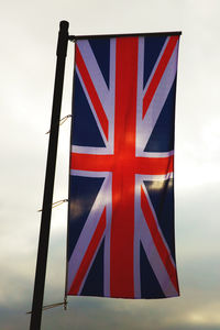 Red flag on pole against the sky