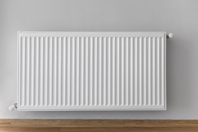 Close-up of white table against wall