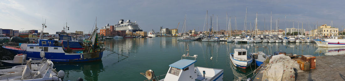 Sailboats moored in harbor