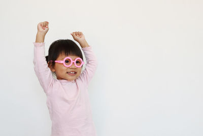 Cute girl standing against white background