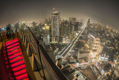 High angle view of illuminated buildings in city at night