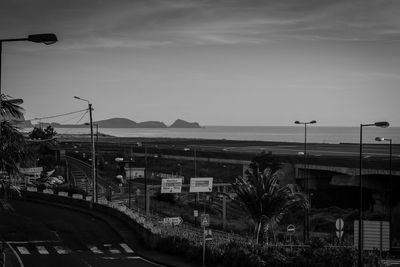 Street by sea against sky