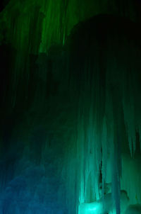 Low angle view of icicles on rock at night