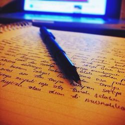 Close-up of pen on book