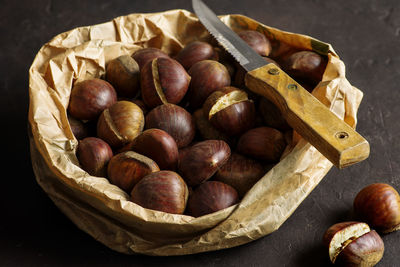 Front view of autumn chestnuts on dark background