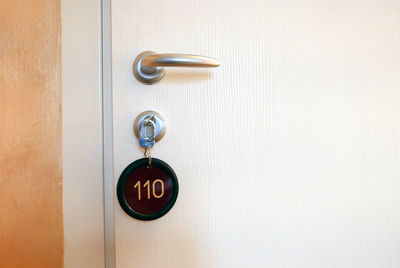 Close-up of key in door lock at hotel