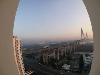 Panoramic view of bridge and cityscape against sky during sunset