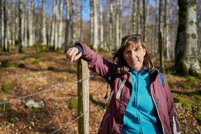 Portrait of a sheltered woman walking in a forest in autumn