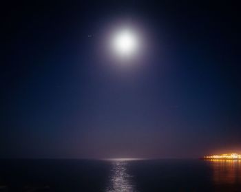 Scenic view of sea against clear sky at night