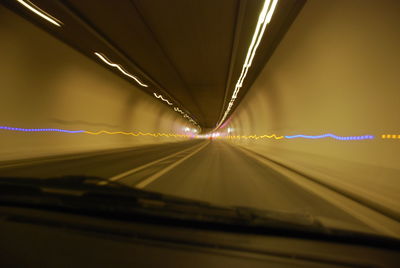 Surface level of road in illuminated tunnel