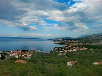 Scenic view of sea and mountains against sky