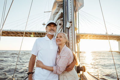 Senior couple on boat at sea against sky