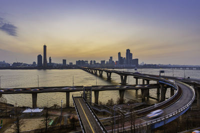 View of buildings in city at sunset