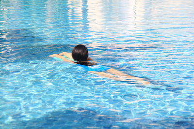 High angle view of woman swimming in pool