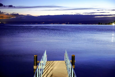 Pier over sea against blue sky