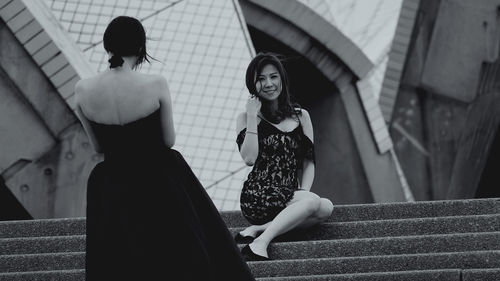 Portrait of women sitting on staircase