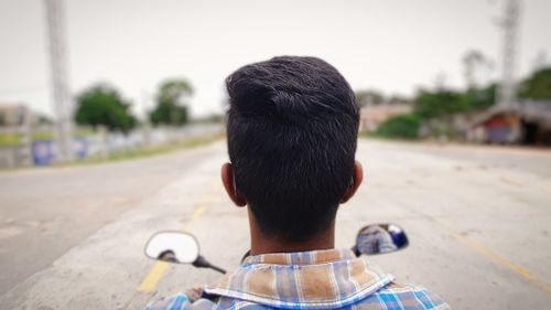 Rear view of man on road in city