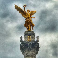 Low angle view of statue against cloudy sky