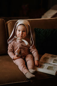 Toddler baby girl in funny hat with ears having fun