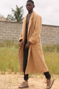 Young man standing against wall