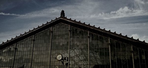 Low angle view of building against cloudy sky